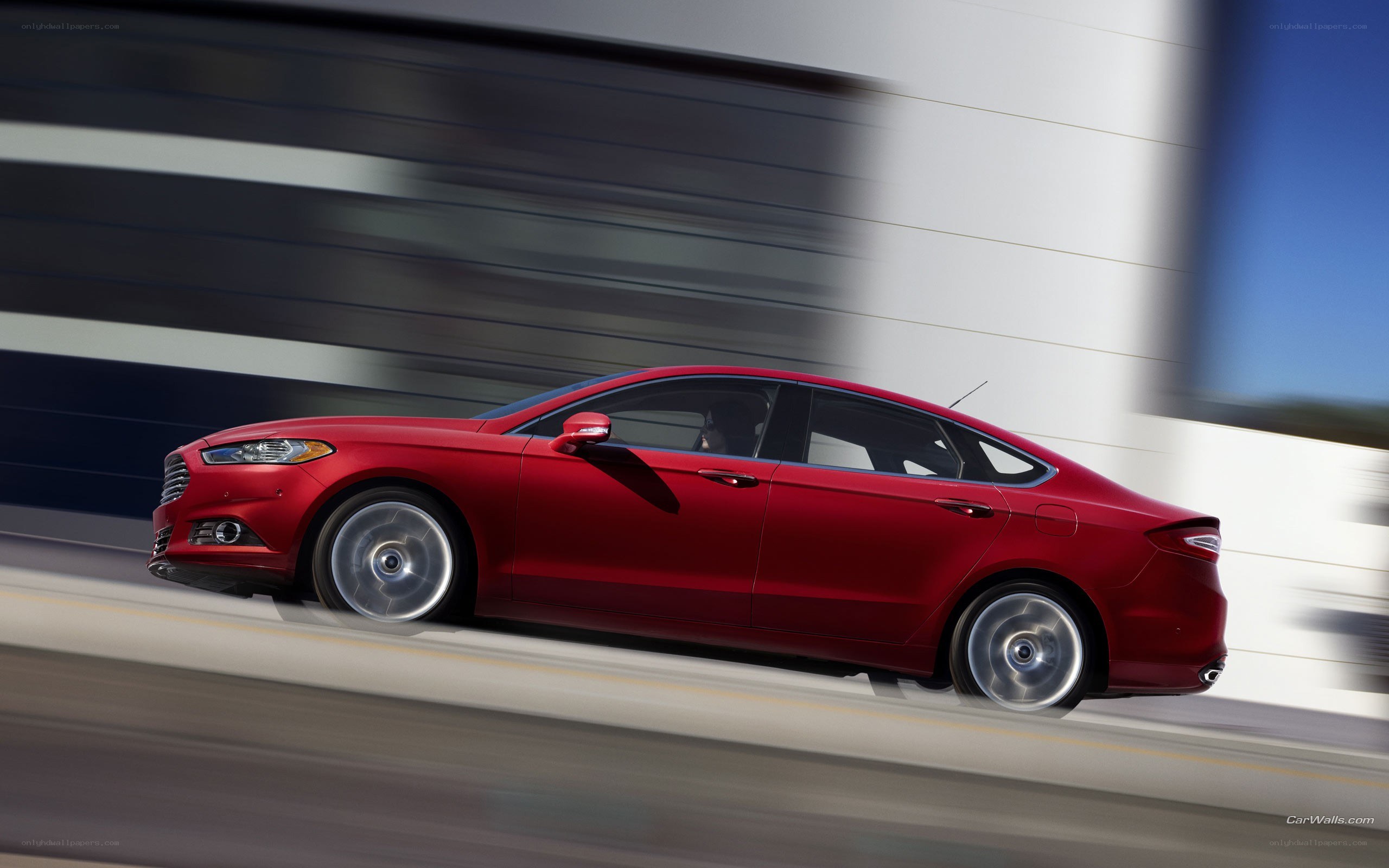 Red sedan in motion