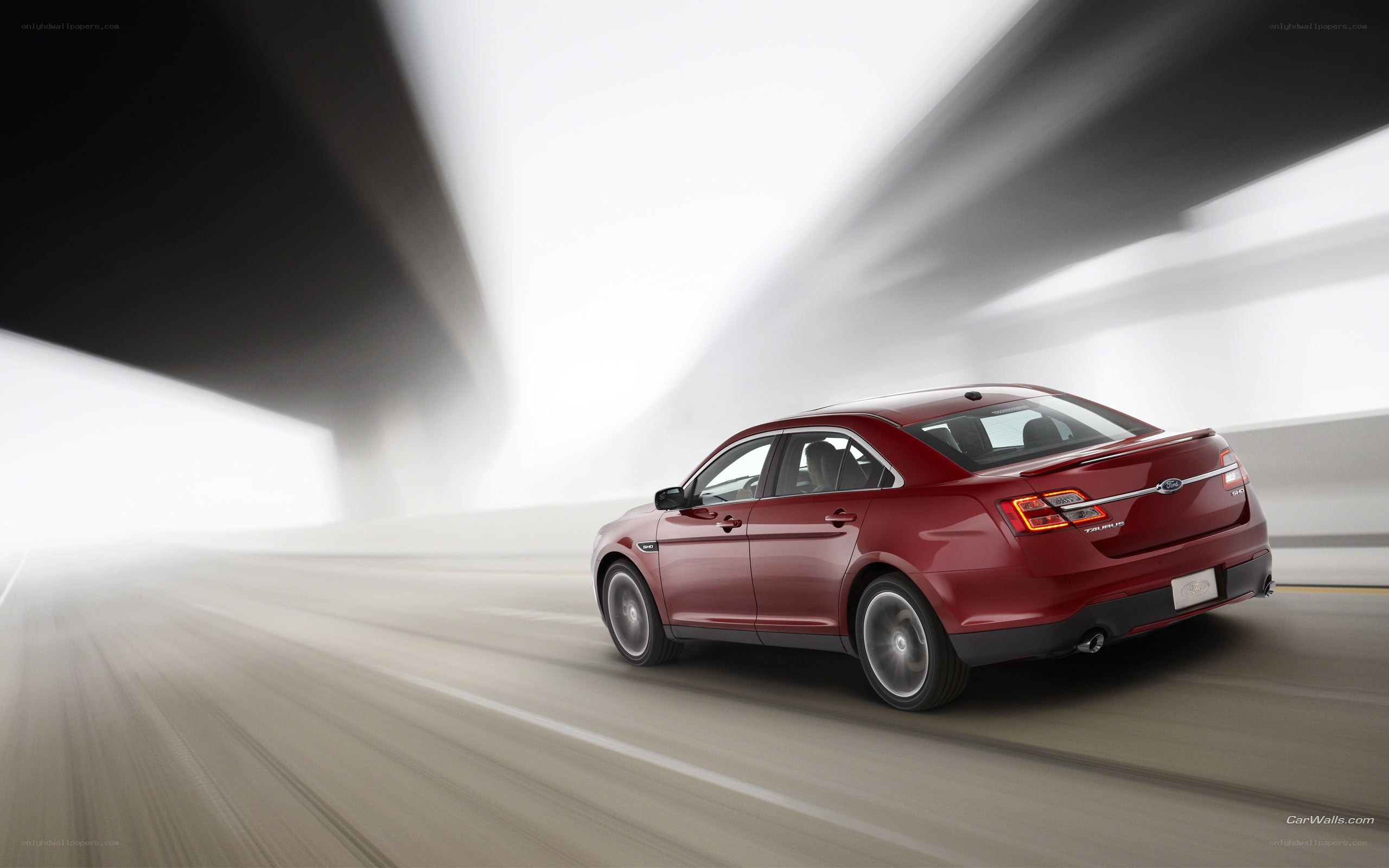 Red sedan in motion
