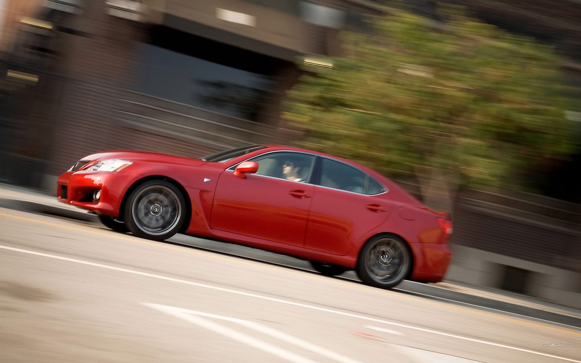 red sedan in motion