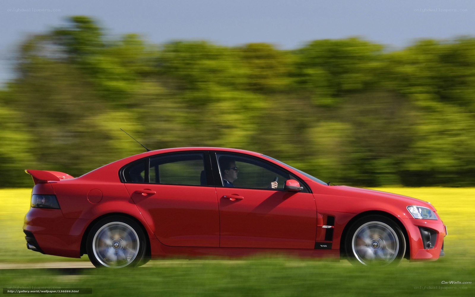 Red sedan in motion