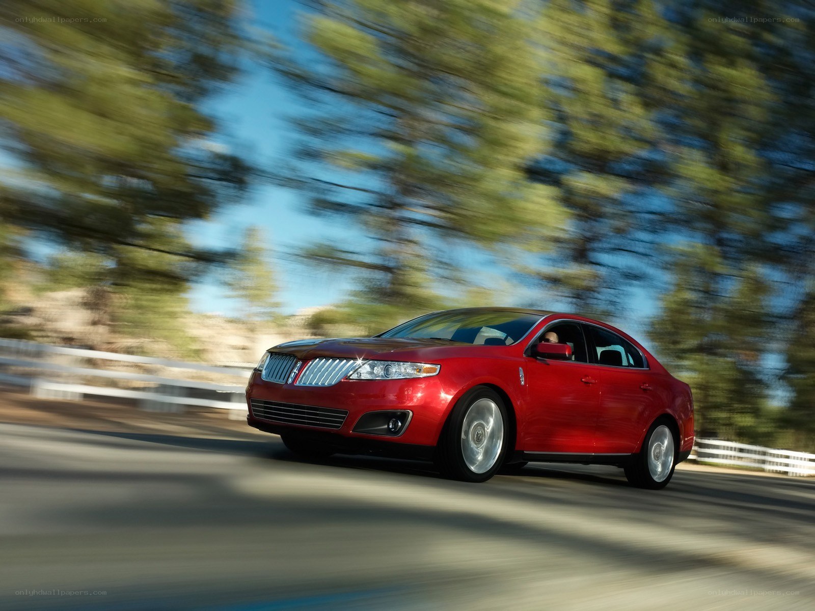 Red sedan in motion on road
