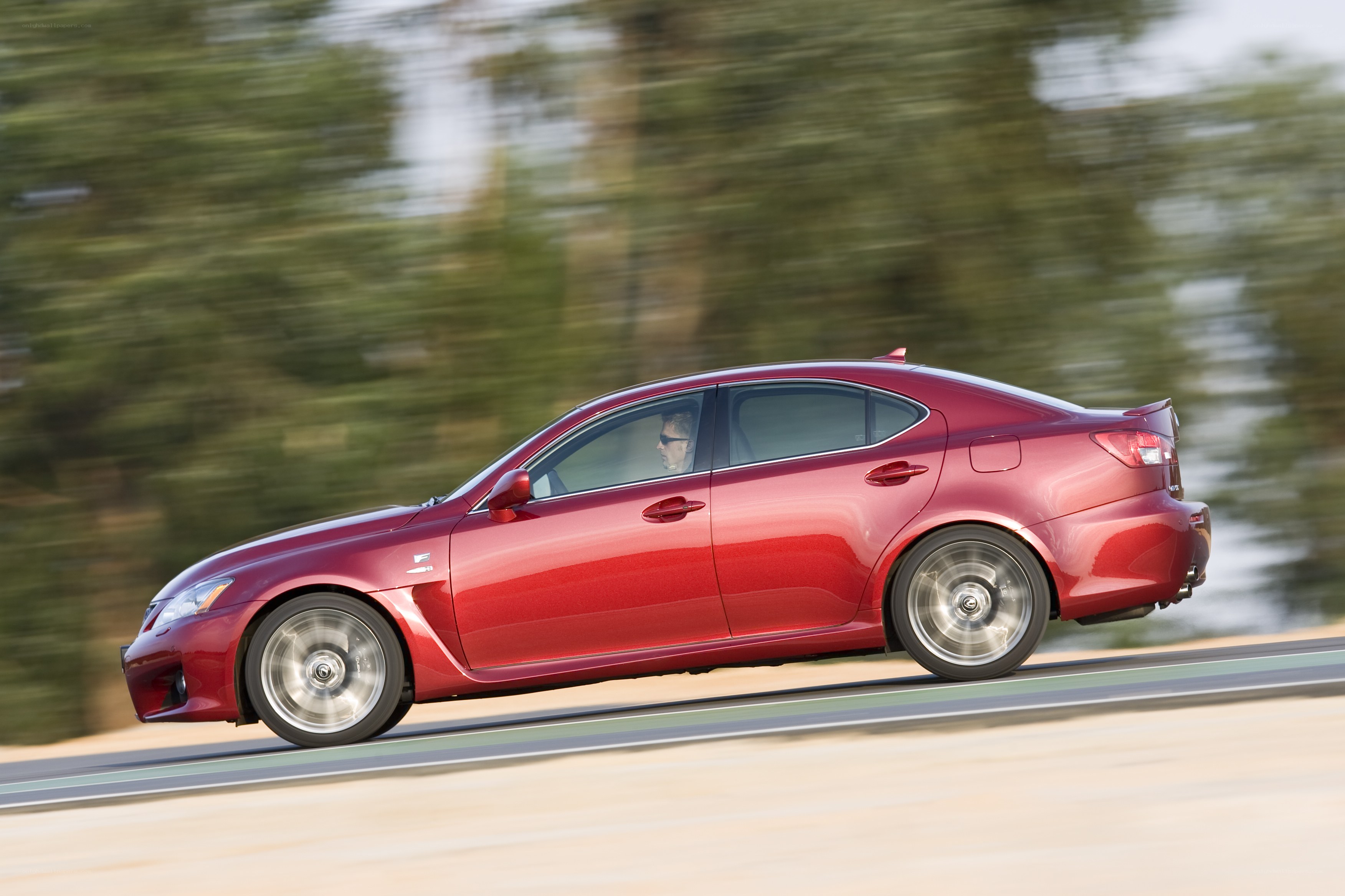 Red sedan in motion on track