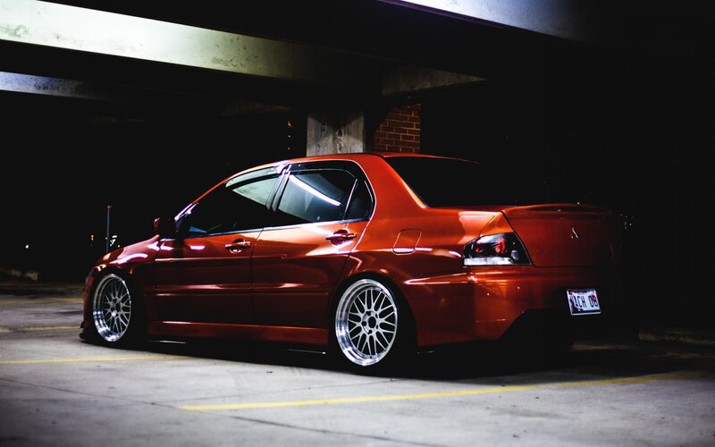 Red sedan in parking garage