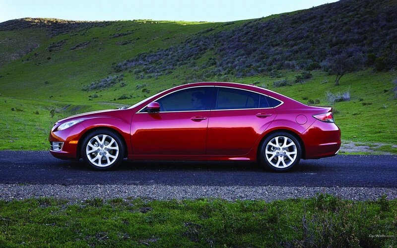 Red sedan on a country road