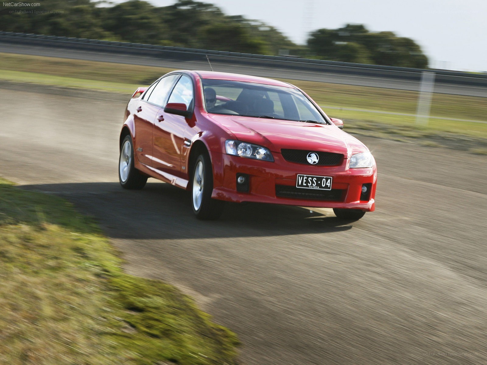 Red sedan on a racetrack