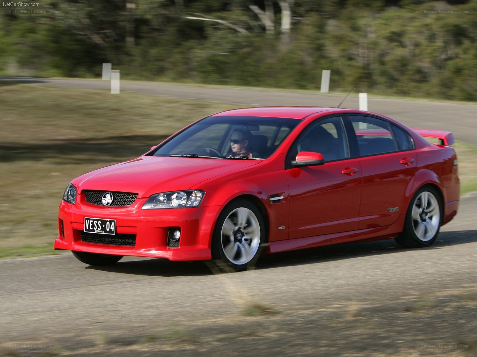 red sedan on a road