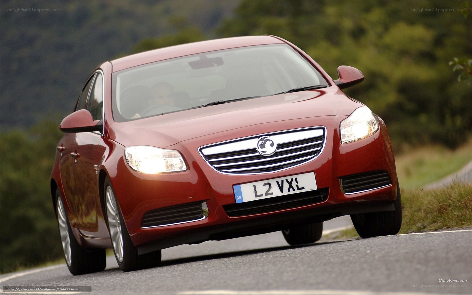Red sedan on a winding road