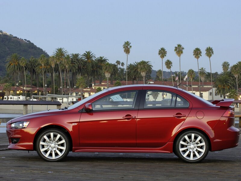 Red sedan on a wooden pier