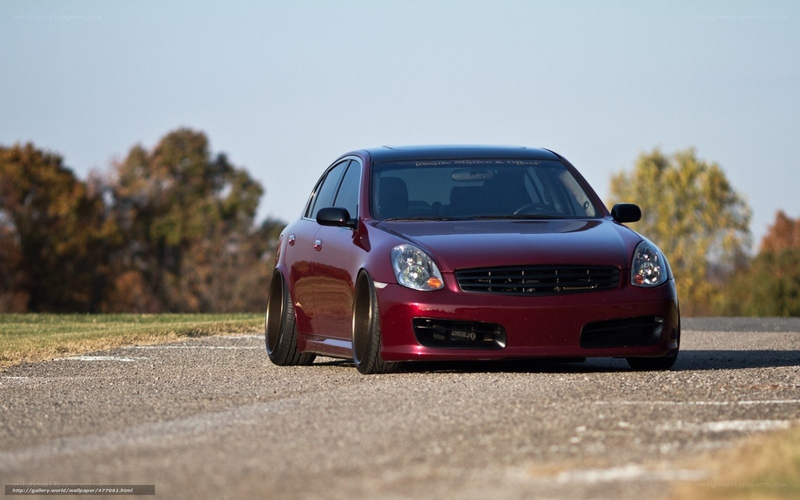 red sedan on asphalt road