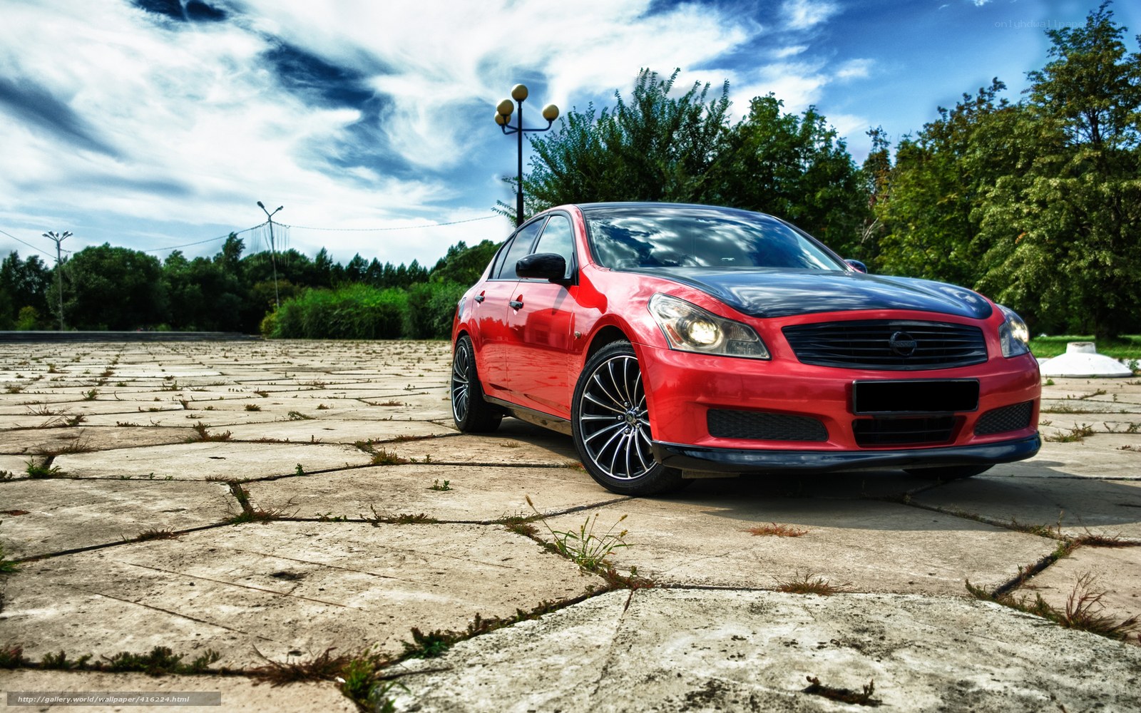 Red sedan on concrete pavement