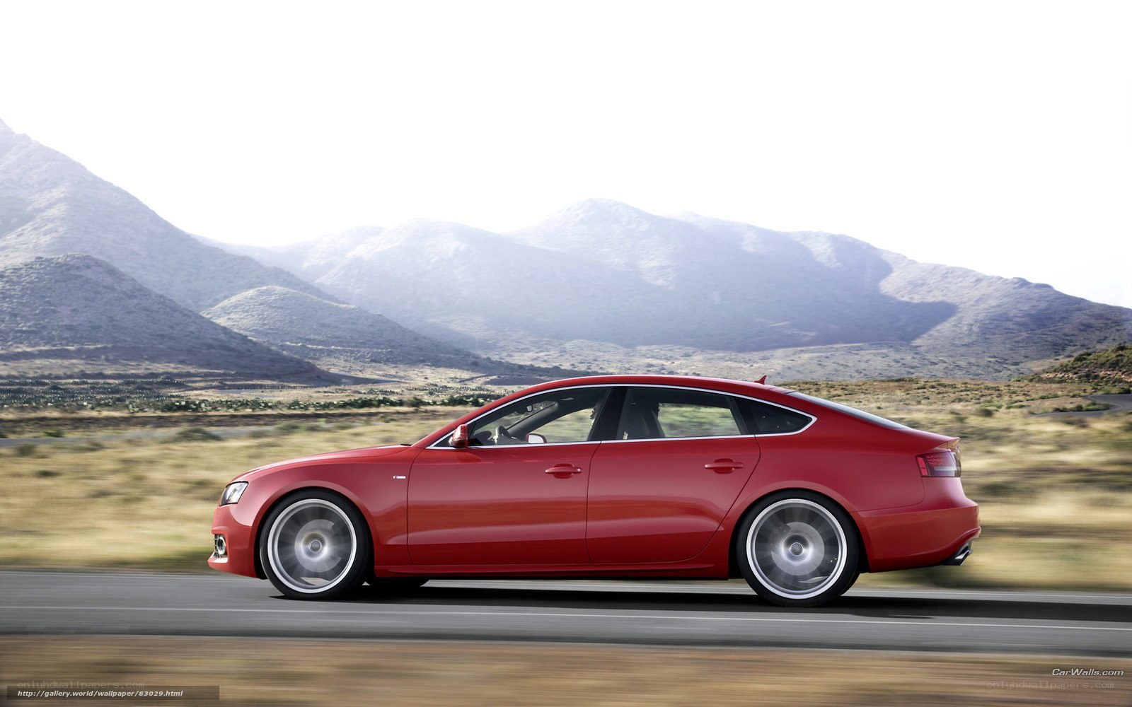 Red sedan on mountain road