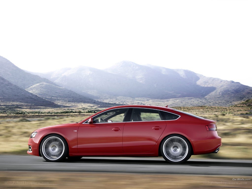 red sedan on mountain road