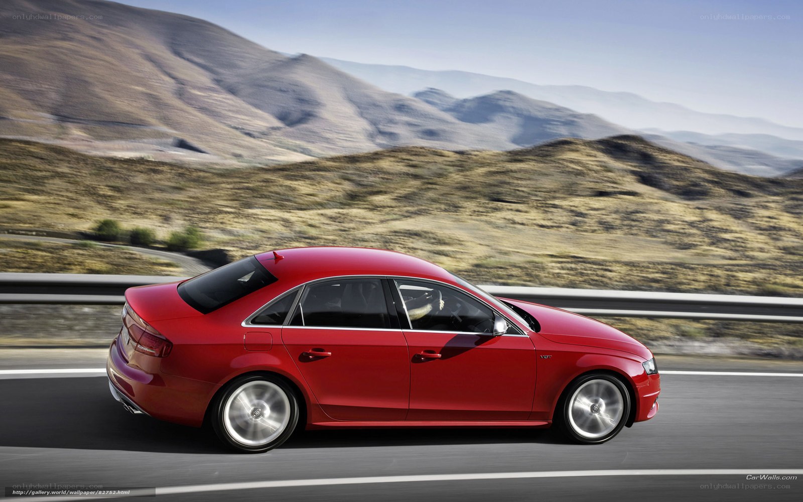 Red sedan on mountain road