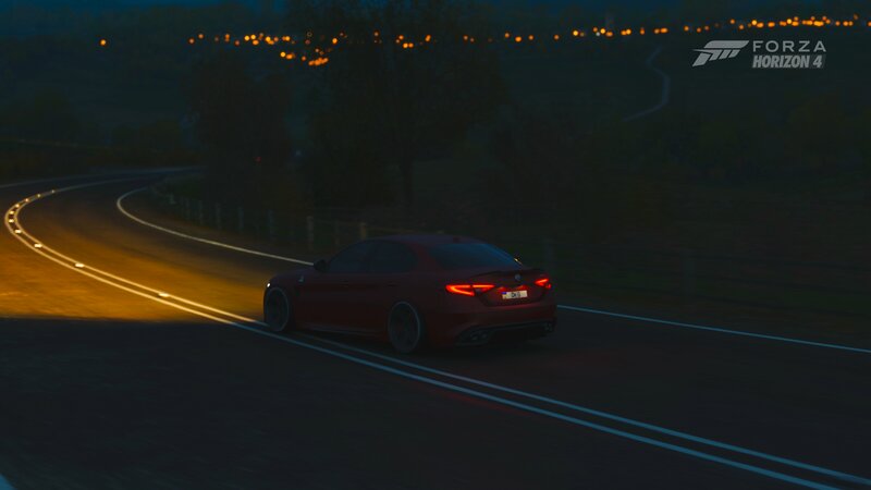 Red Sedan on Road — Dark