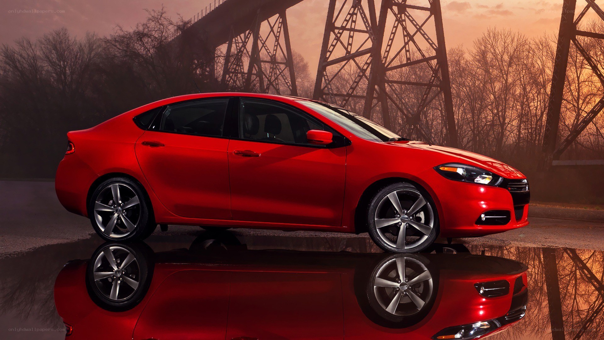 Red sedan on wet pavement