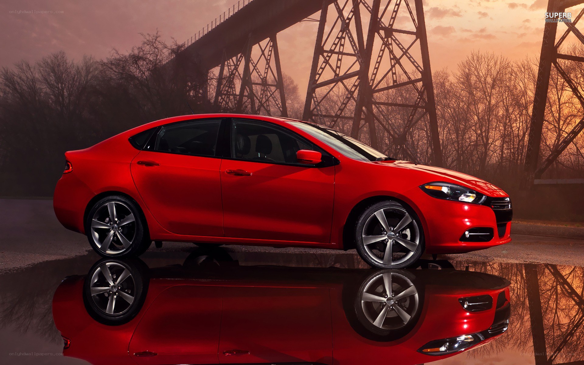Red sedan on wet pavement