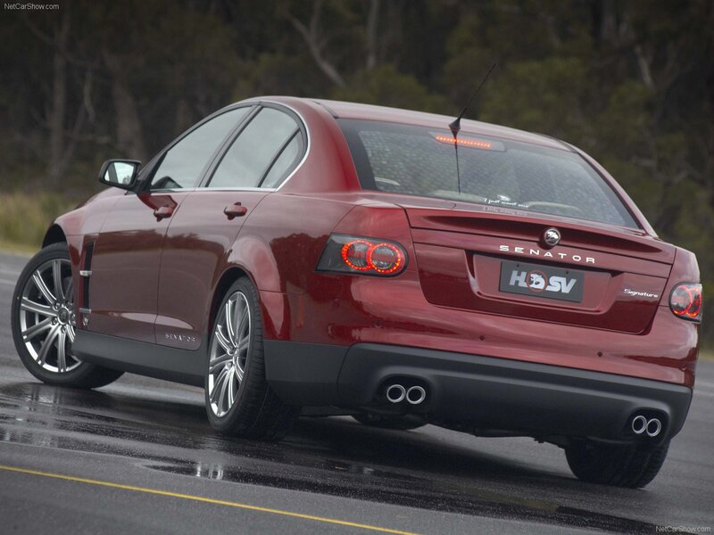 red sedan on wet road