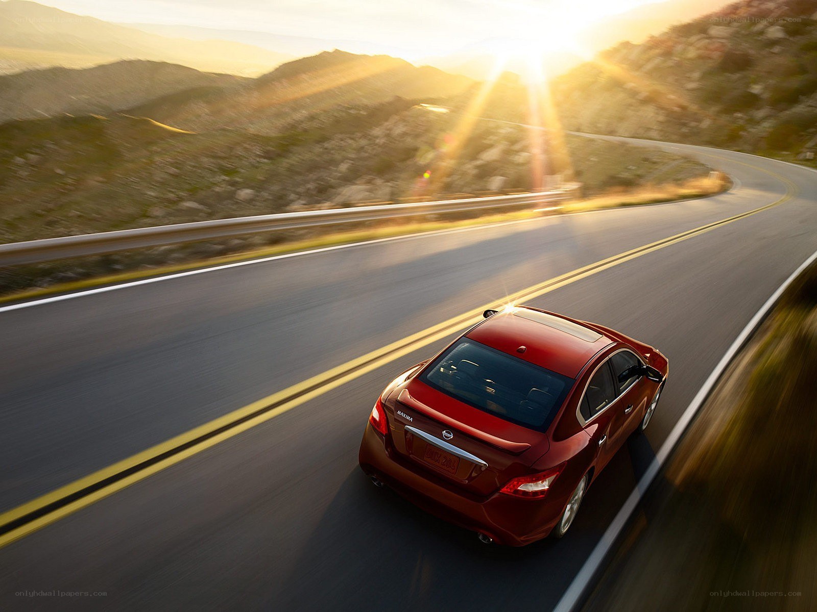 Red sedan on winding road