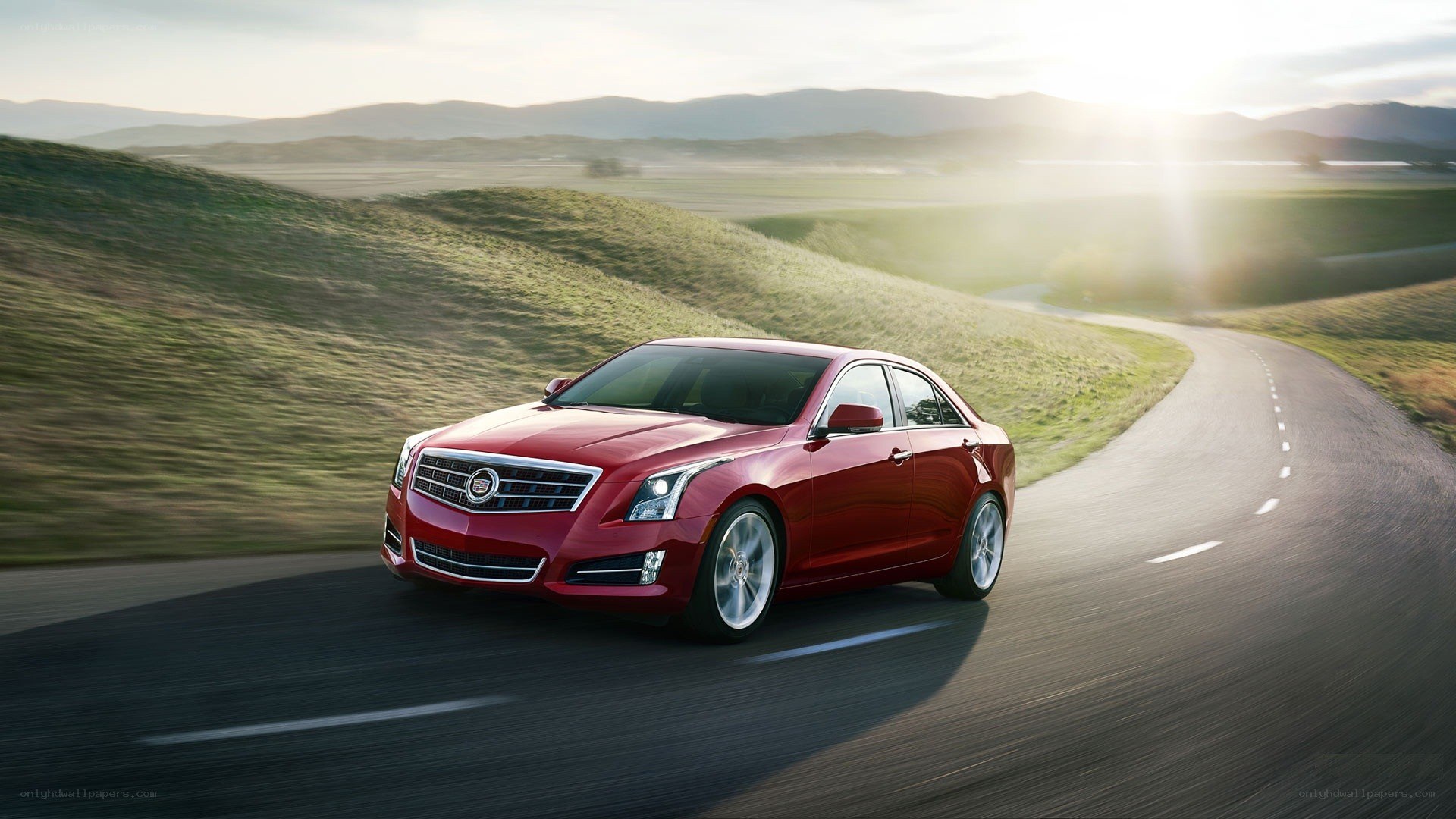 Red sedan on winding road