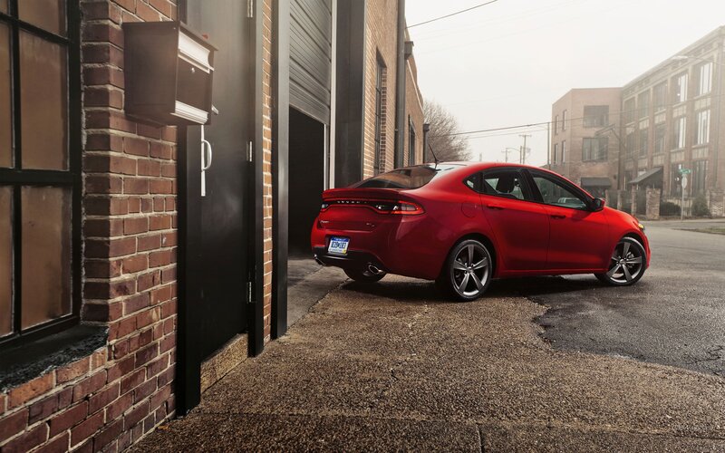 Red sedan parked in alley