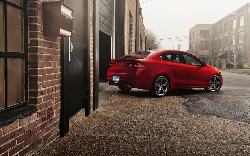 Red sedan parked in alley