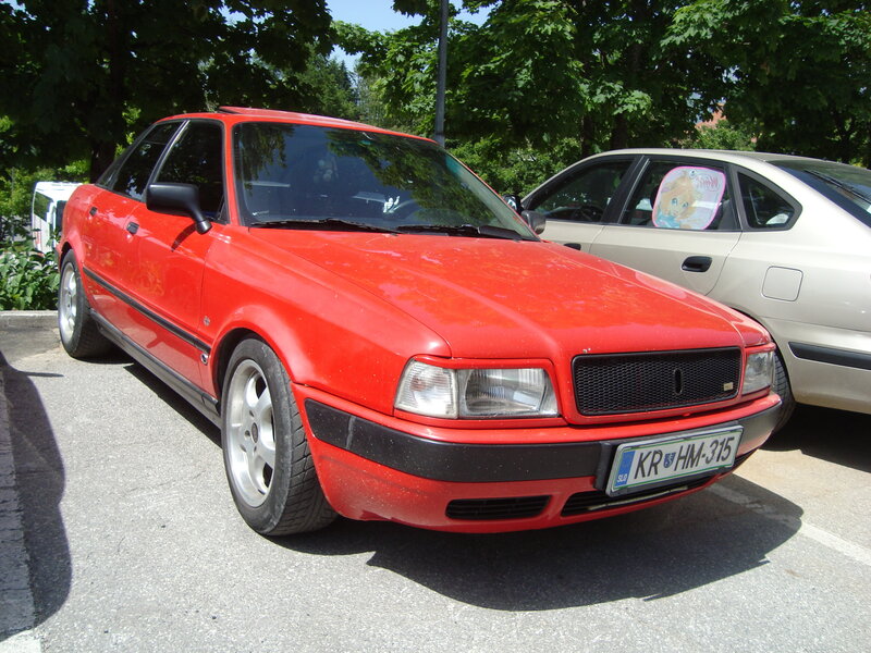 Red sedan parked in lot