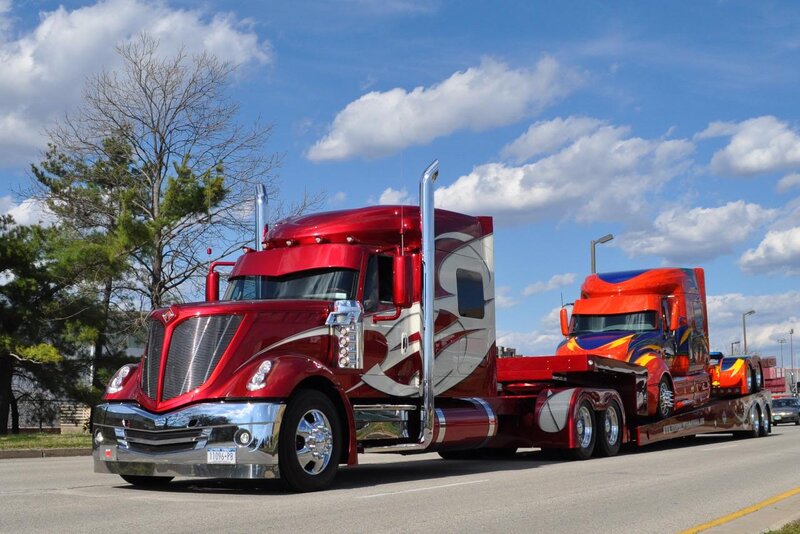 Red Semi-truck Hauling Another Truck