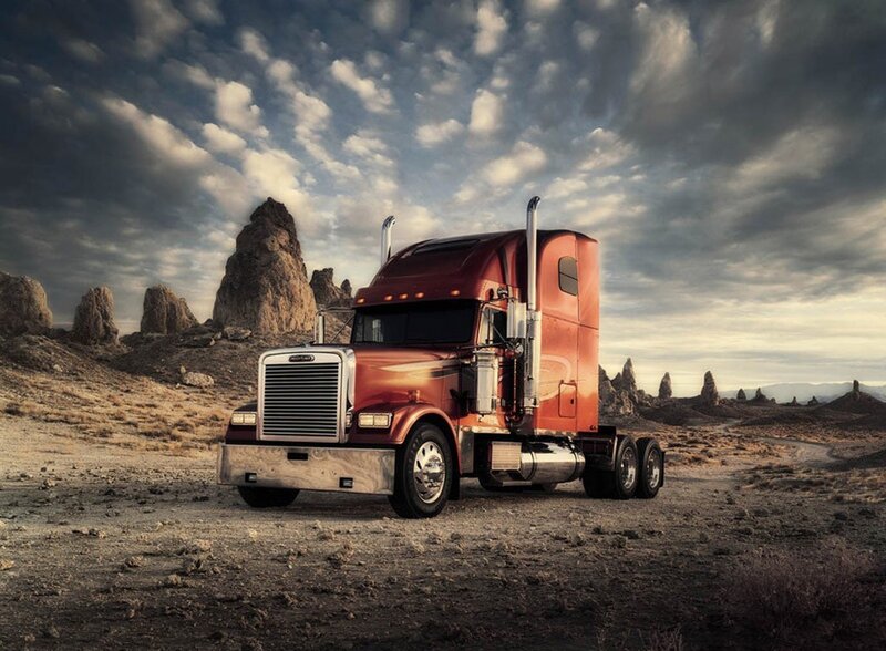 Red semi-truck in desert landscape