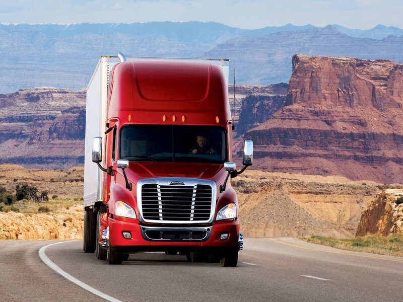 Red semi-truck on desert highway
