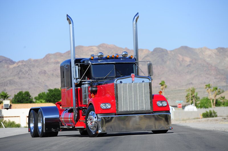 red semi-truck on desert road