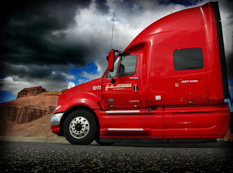 Red semi-truck on desert road