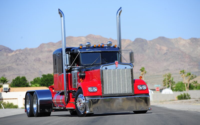 red semi-truck on desert road