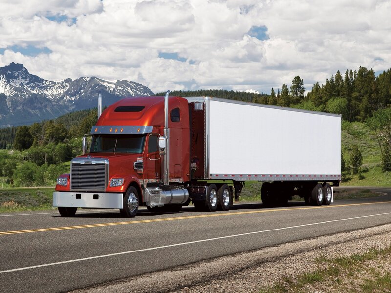 Red semi-truck on mountain road