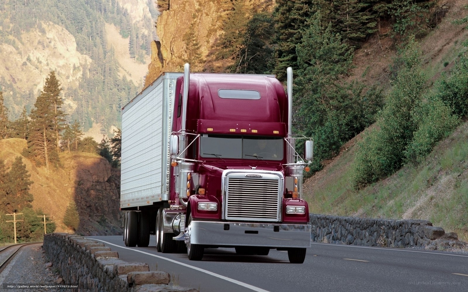 Red semi-truck on mountain road