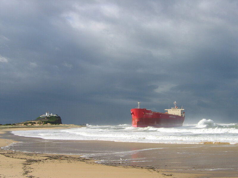 Red ship stranded on beach