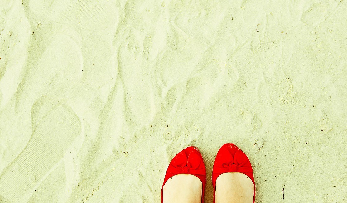 red shoes on sandy beach
