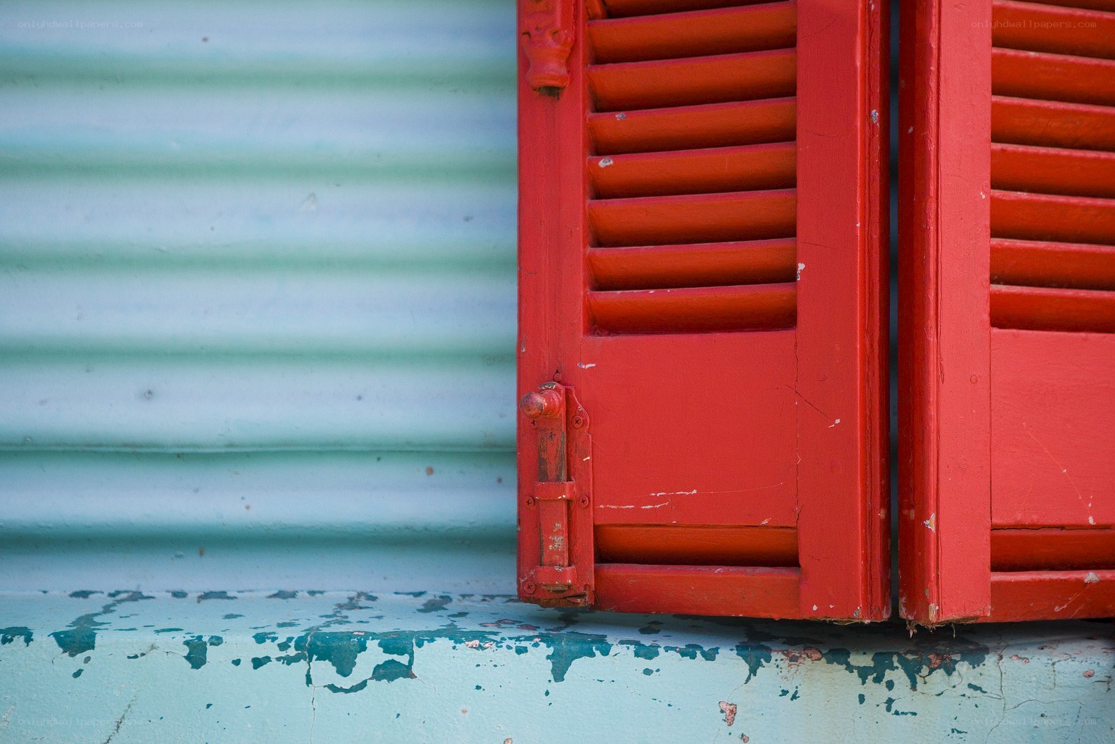 Red shutters on a weathered wall