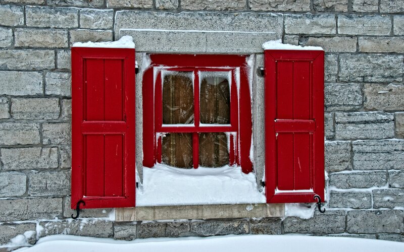 Red Shutters on Stone Wall