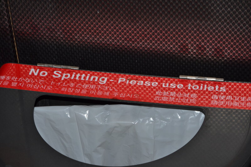 Red Sign on Trash Can