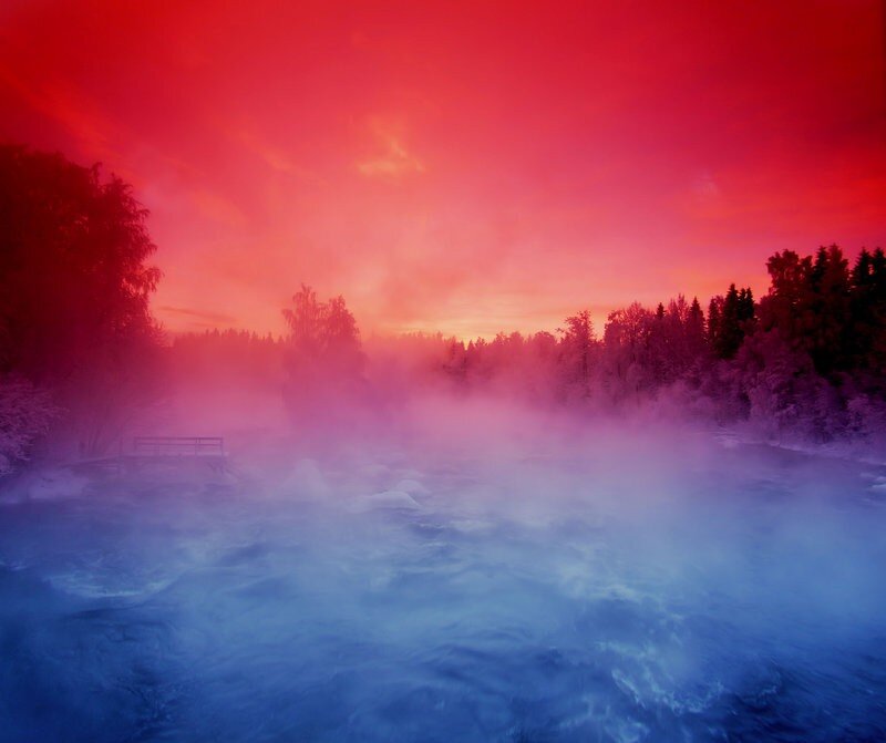 Red sky over a misty river