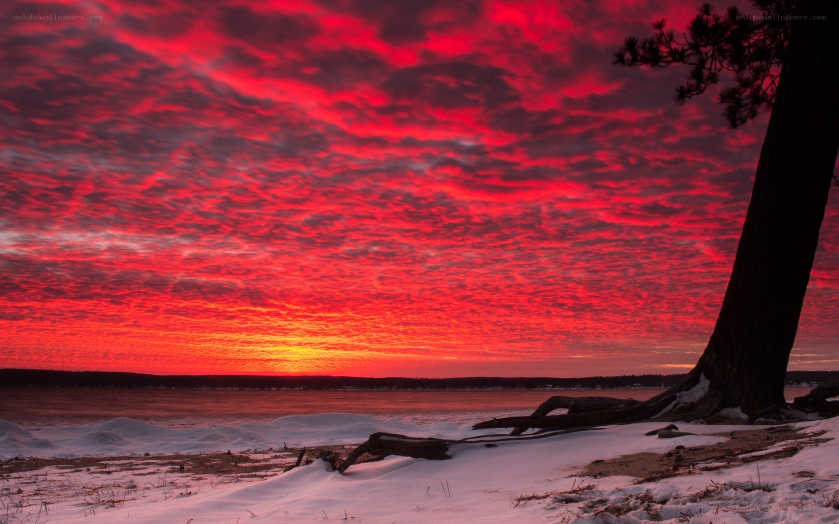 Red sky over snowy lake