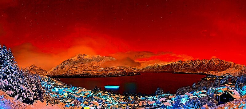 Red sky over snowy mountains
