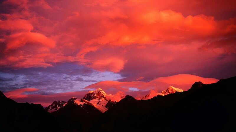 Red sky over snowy mountains