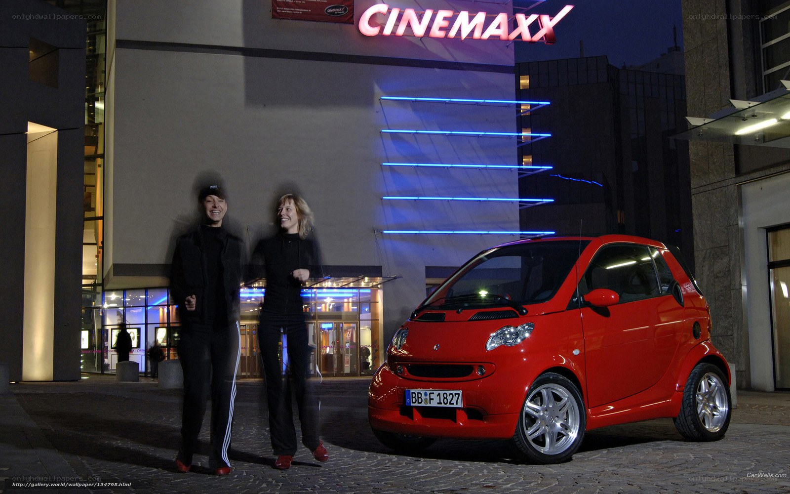 Red smart car at cinema