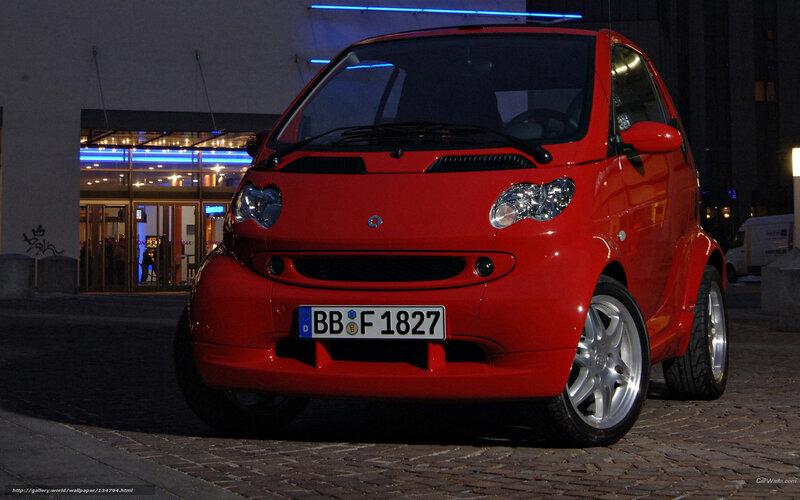 Red smart car at night