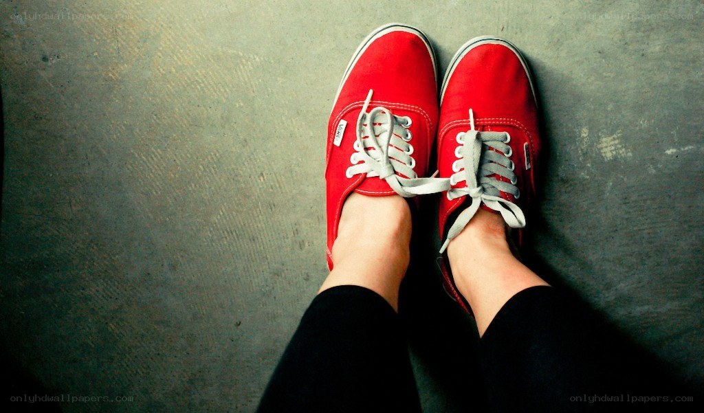 red sneakers on concrete