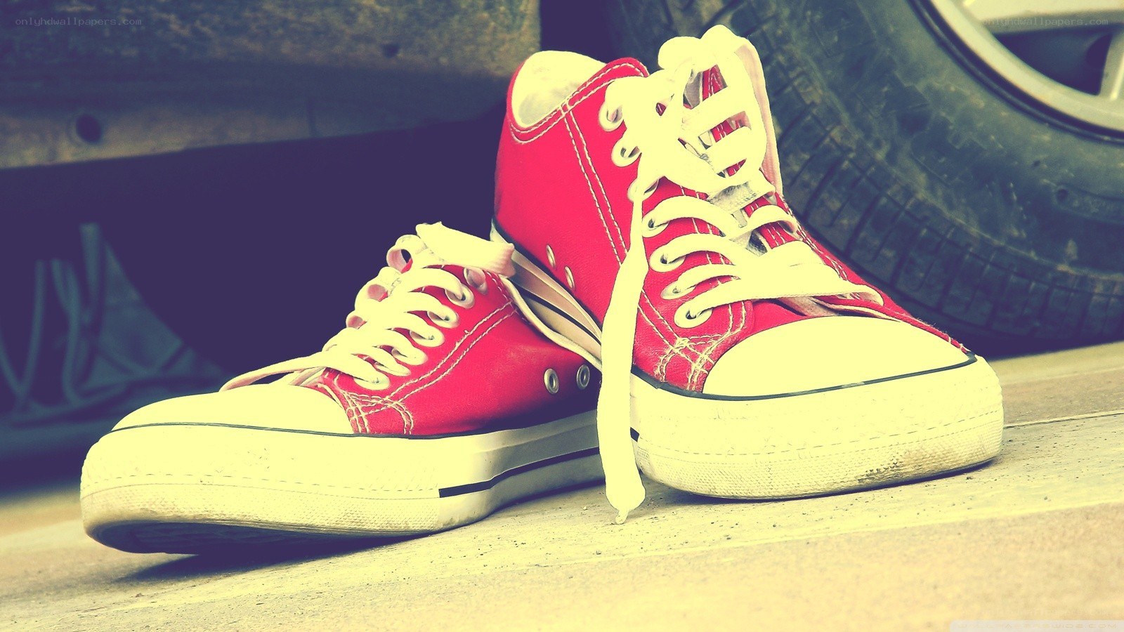 red sneakers on concrete