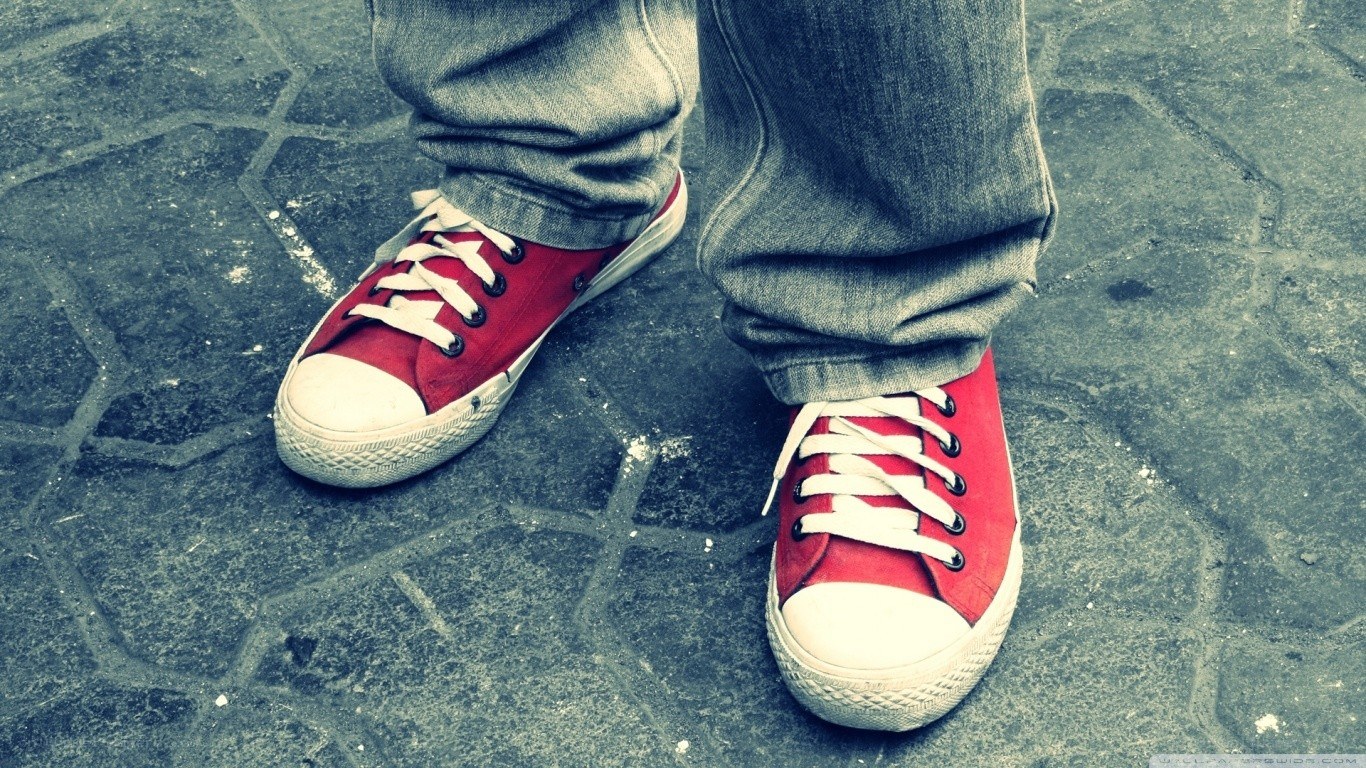 red sneakers on pavement
