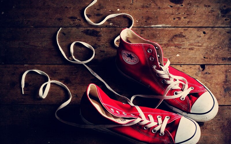 Red sneakers on wooden floor