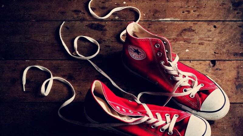Red sneakers on wooden floor